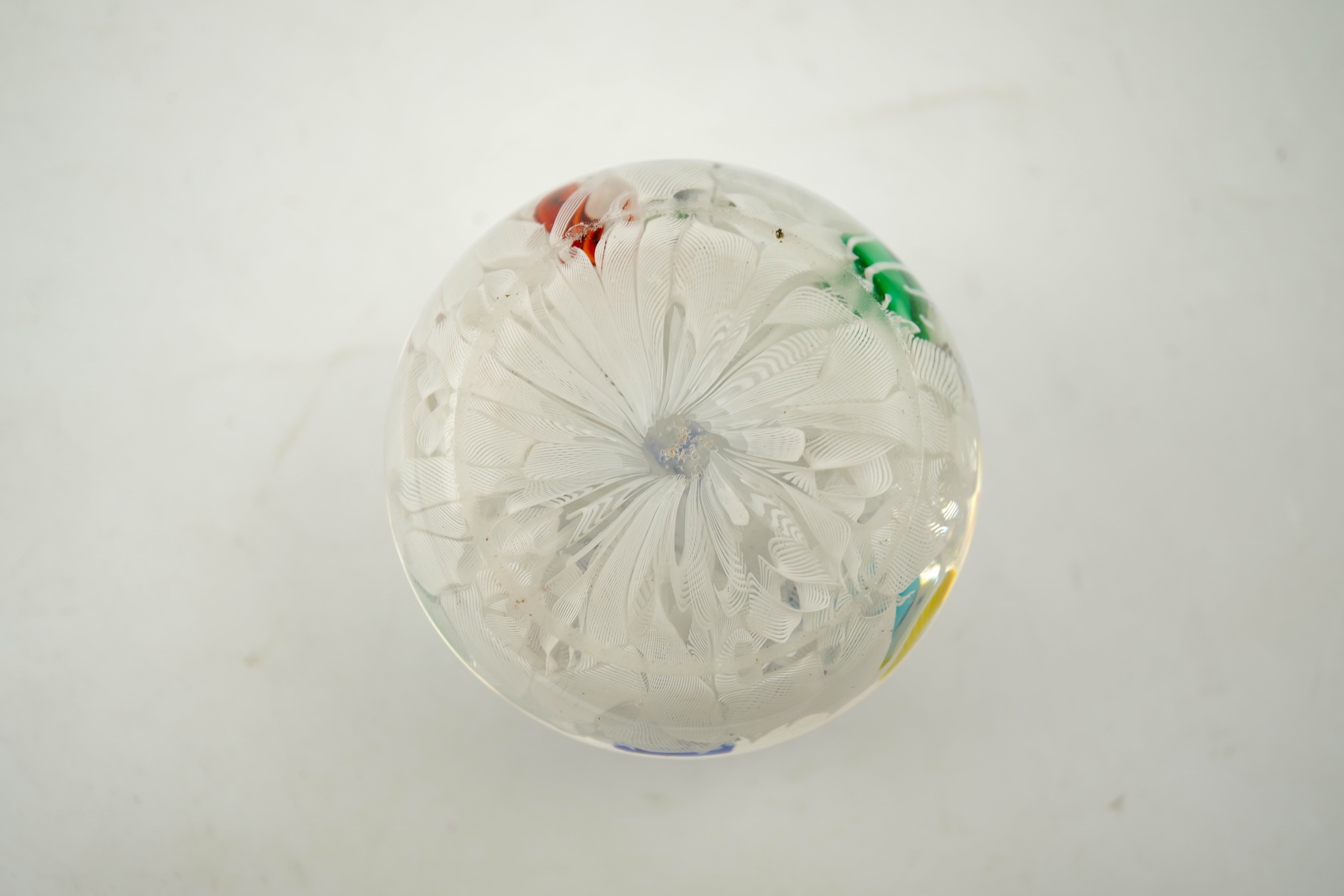 A Baccarat silhouette cane upset muslin ground paperweight, one cane dated 1848